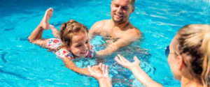 Family swimming in a pool